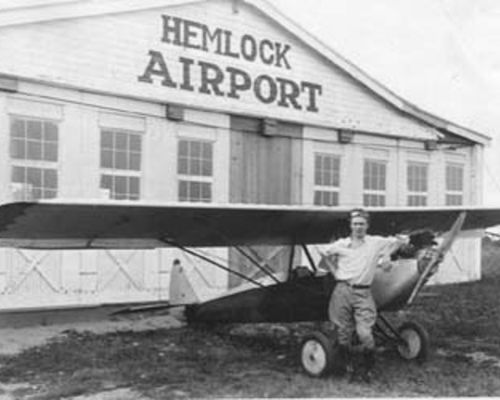 Man and Plane Hemlock Airport